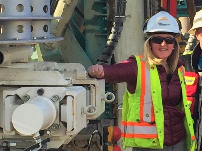 female employee in ppe on construction site