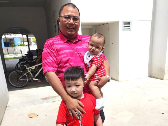 father and children smiling for camera