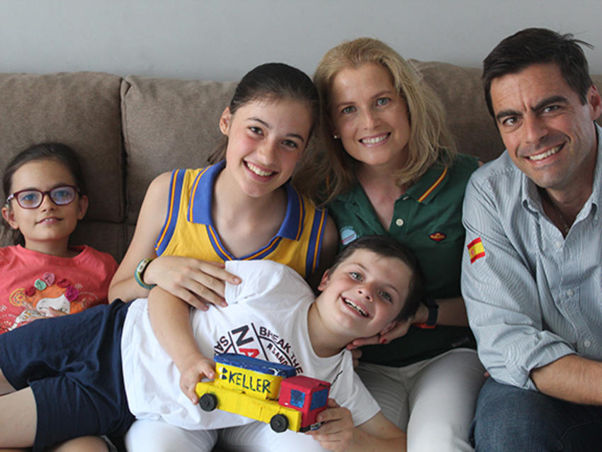 smiling family of five with keller truck toy