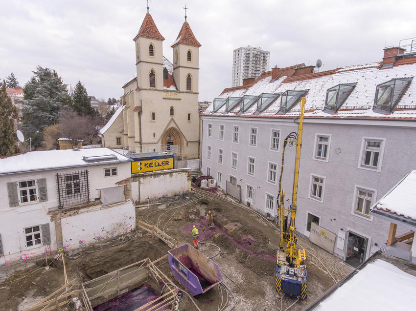 keller rig on site between three old buildings