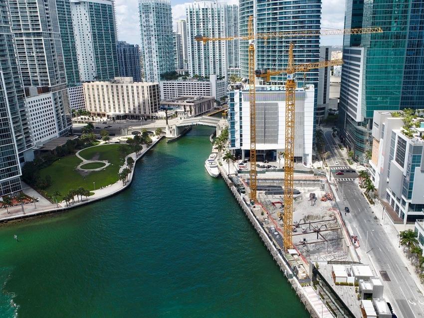 river running through skyscraper buildings