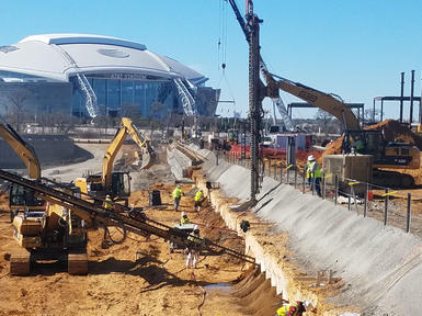 stadium surrounded by working construction site and rigs